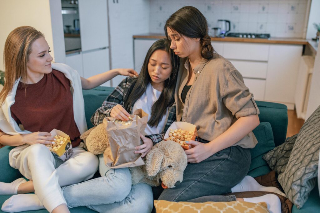 Friends consoling an emotionally stressed girl.